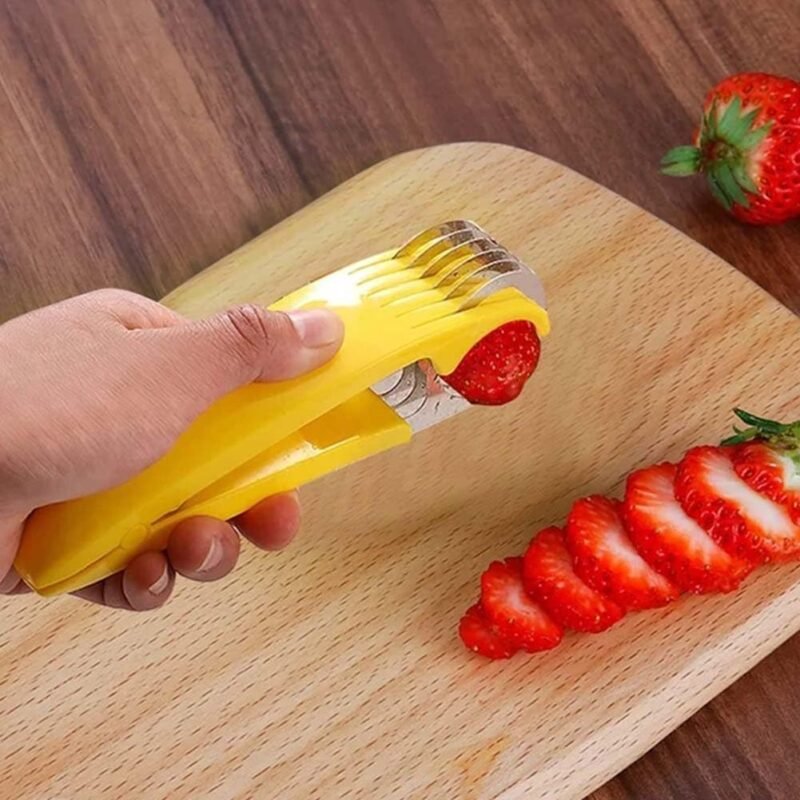 Coupe-banane jaune coupant des fraises sur une planche en bois